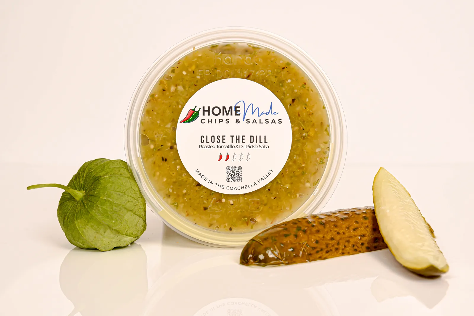 A tub of Close the Dill salsa with its fresh ingredients