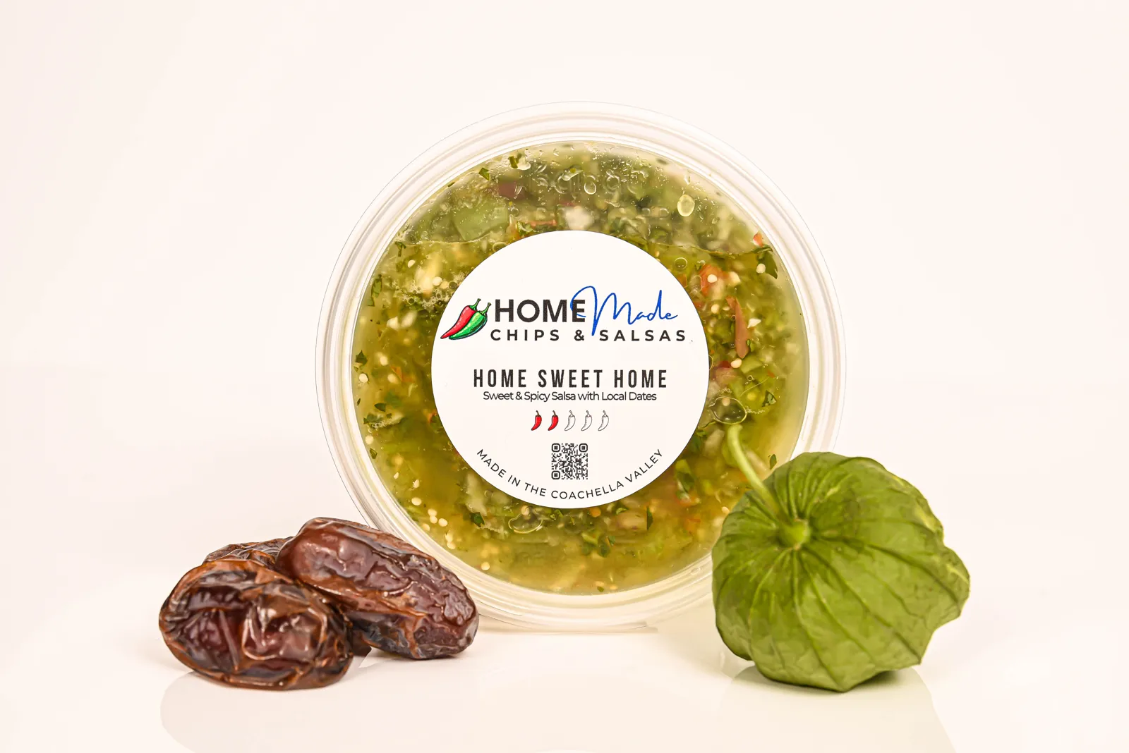 A tub of Home Sweet Home salsa with its fresh ingredients