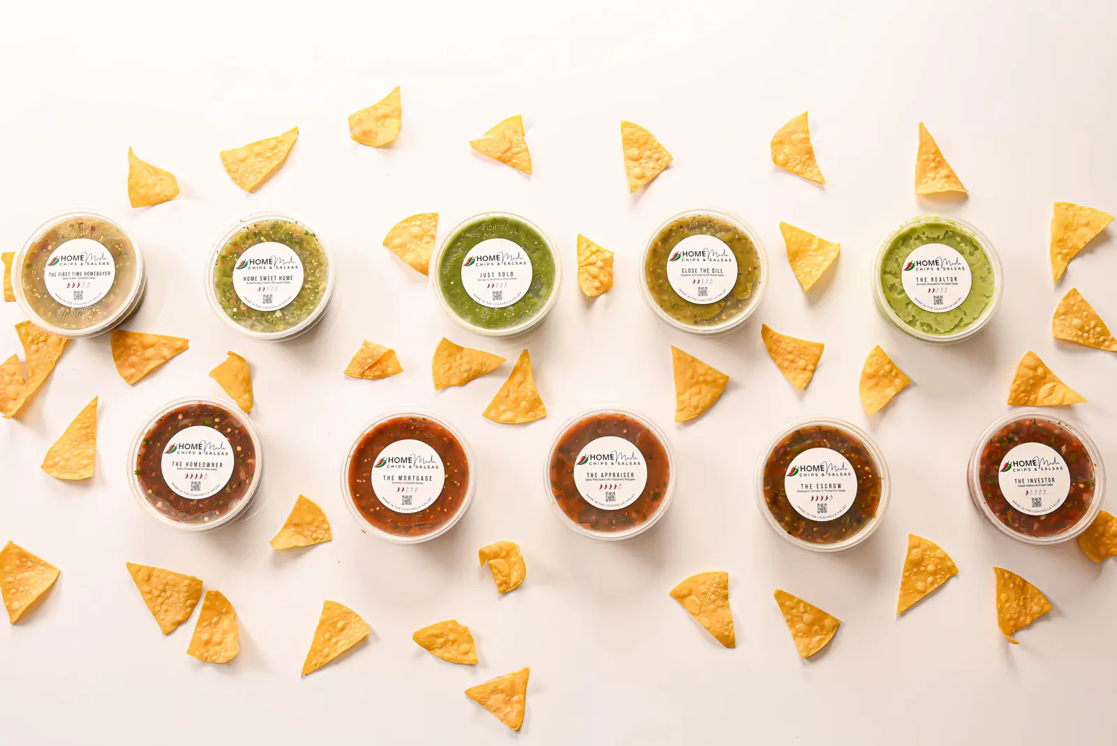 All ten HOMEmade salsas in labeled tubs, seen from above among scattered chips